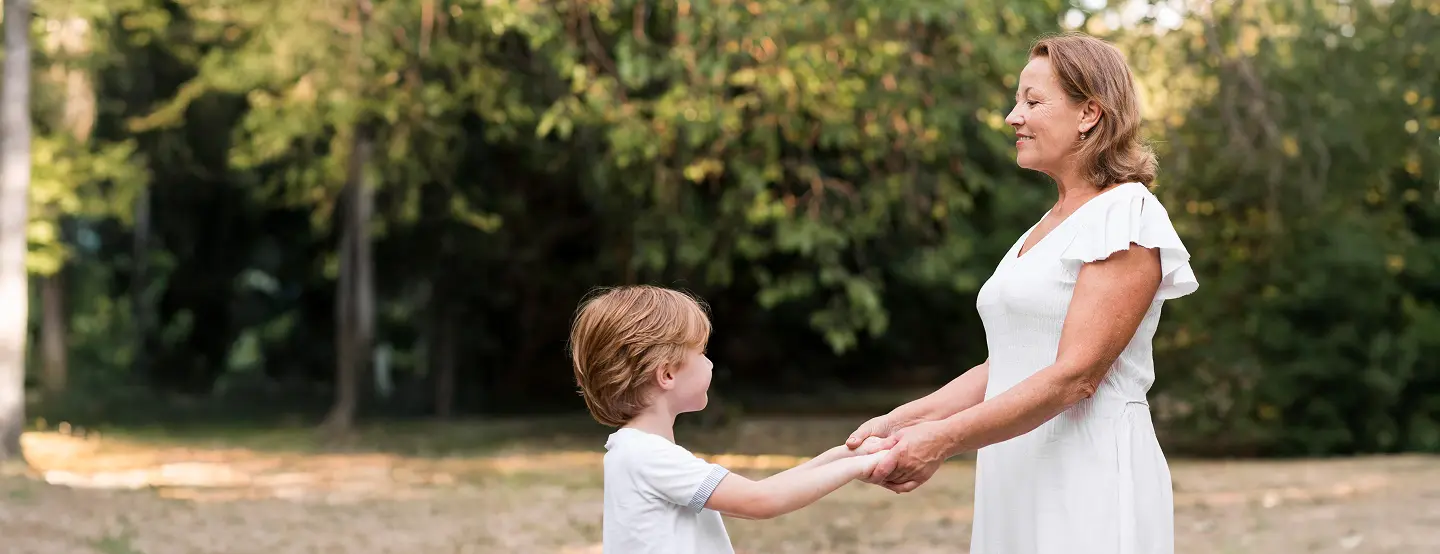 side view grandma kid holding hands